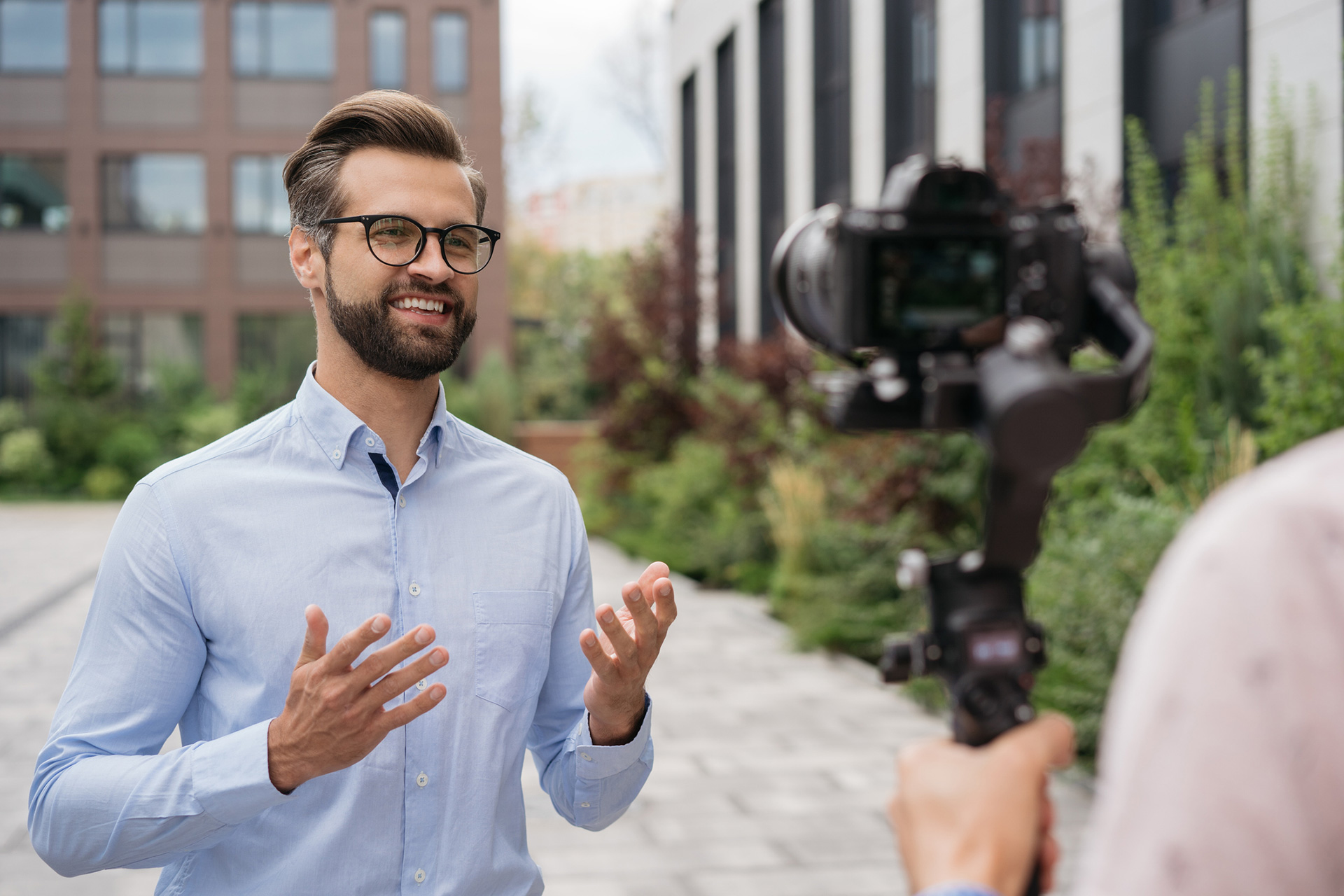 Handsome journalist or news reporter broadcasting on the street.